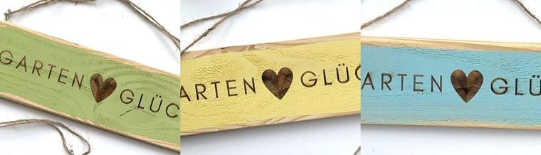 Drei Gartenschilder in Grün, Gelb und Türkis